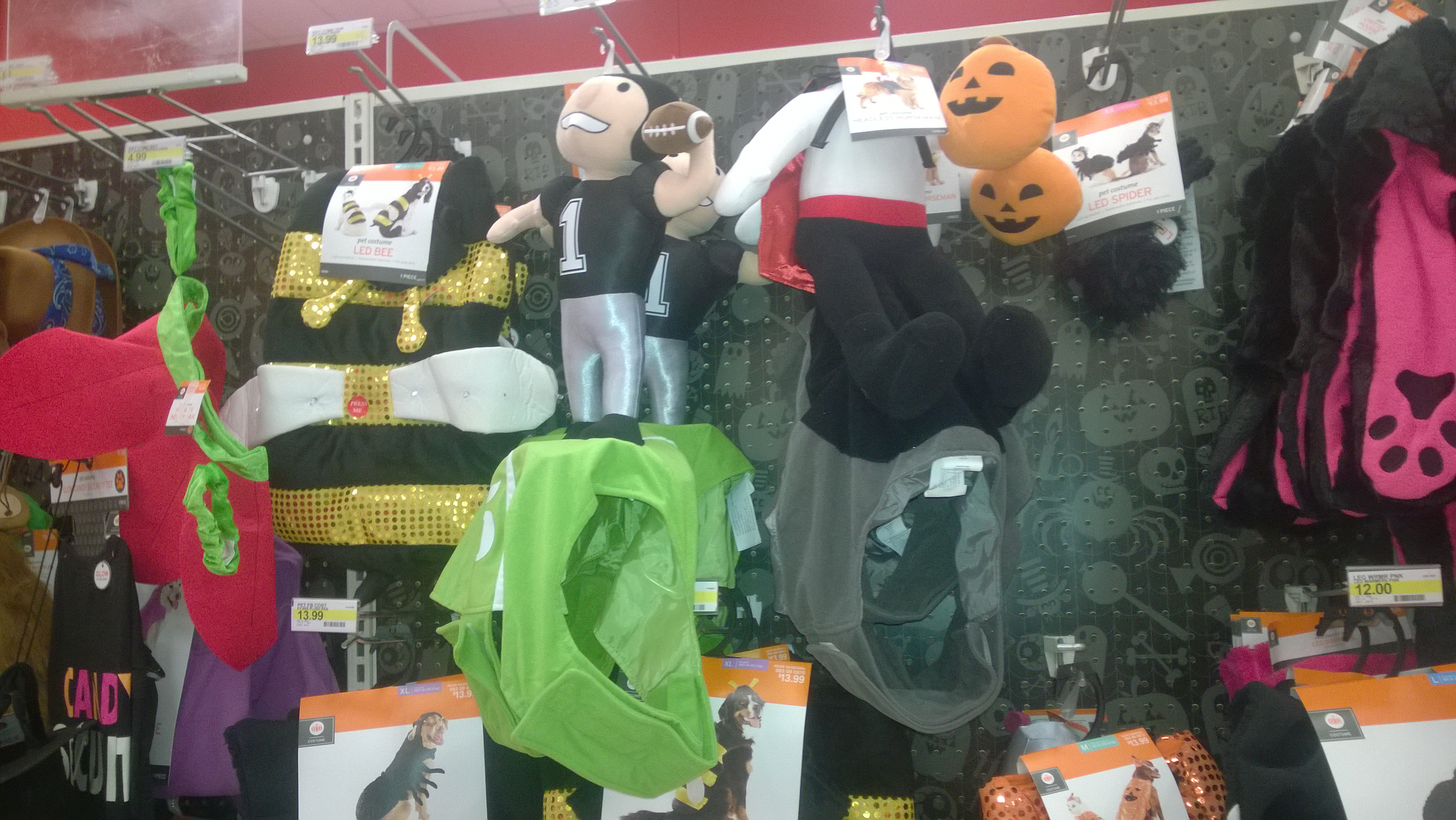 A wide shop display of Halloween costumes and character-shaped treat bags.